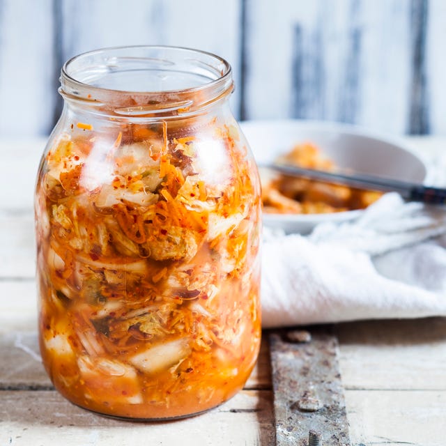 glass of homemade korean kimchi with chinese cabbage, scallions and carrots