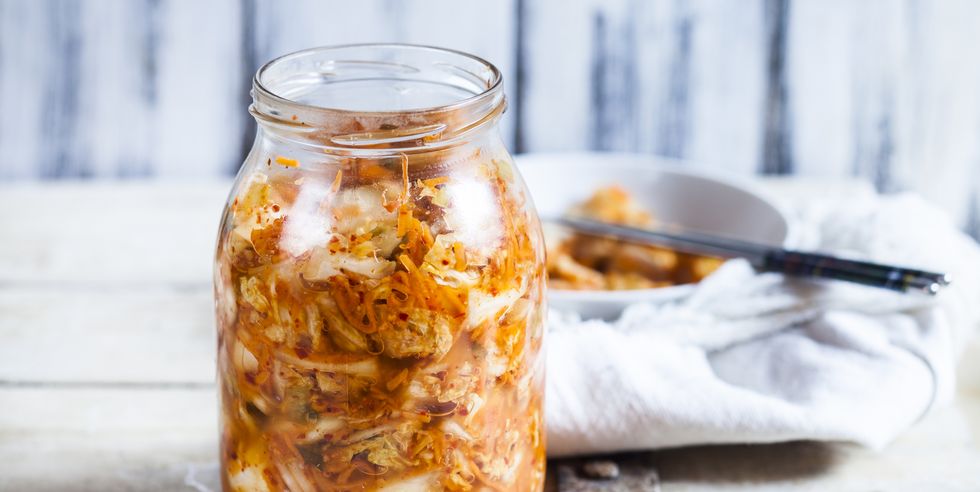 glass of homemade korean kimchi with chinese cabbage, scallions and carrots
