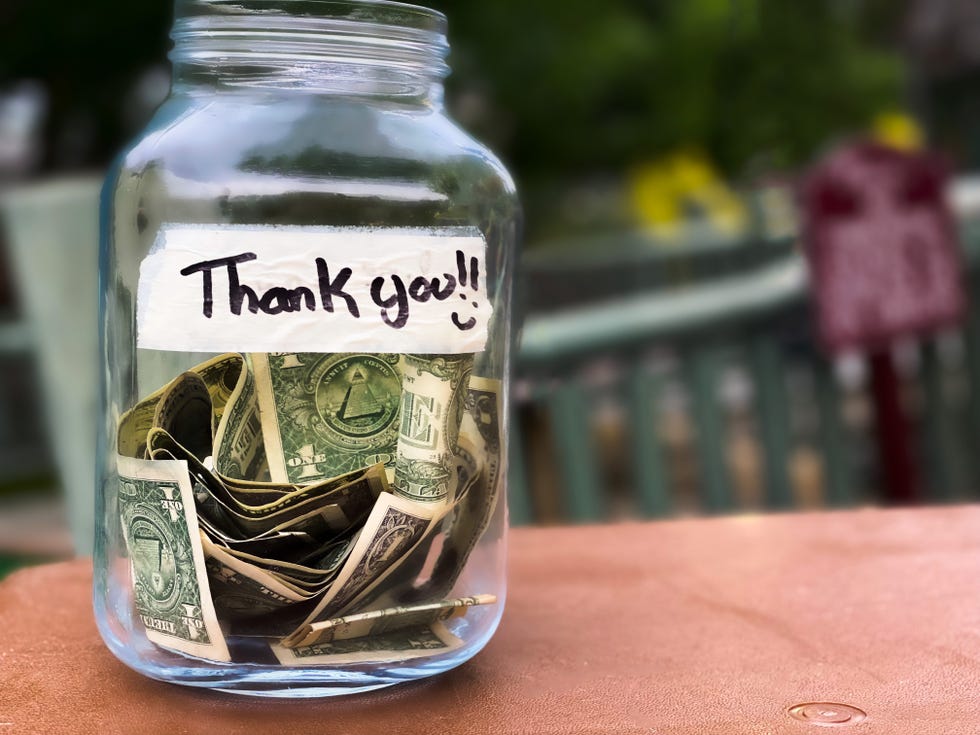 glass tip jar at checkout counter