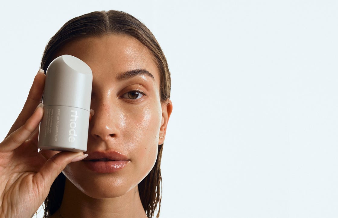 a woman holding a white phone