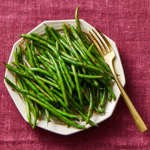 glazed green beans on a white plate