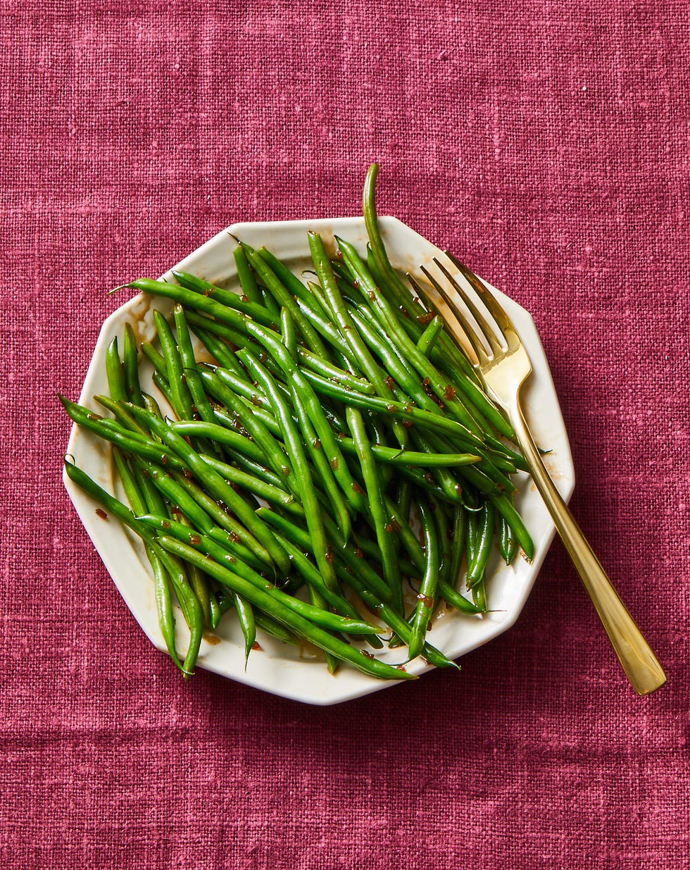 glazed green beans on a white plate