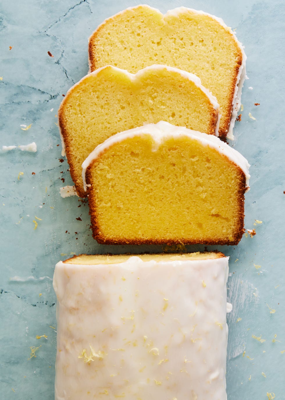 lemon olive oil cake with a glaze and lemon zest on top