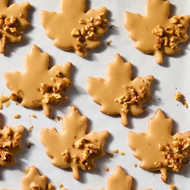 glazed maple leaf cookies topped with pecans