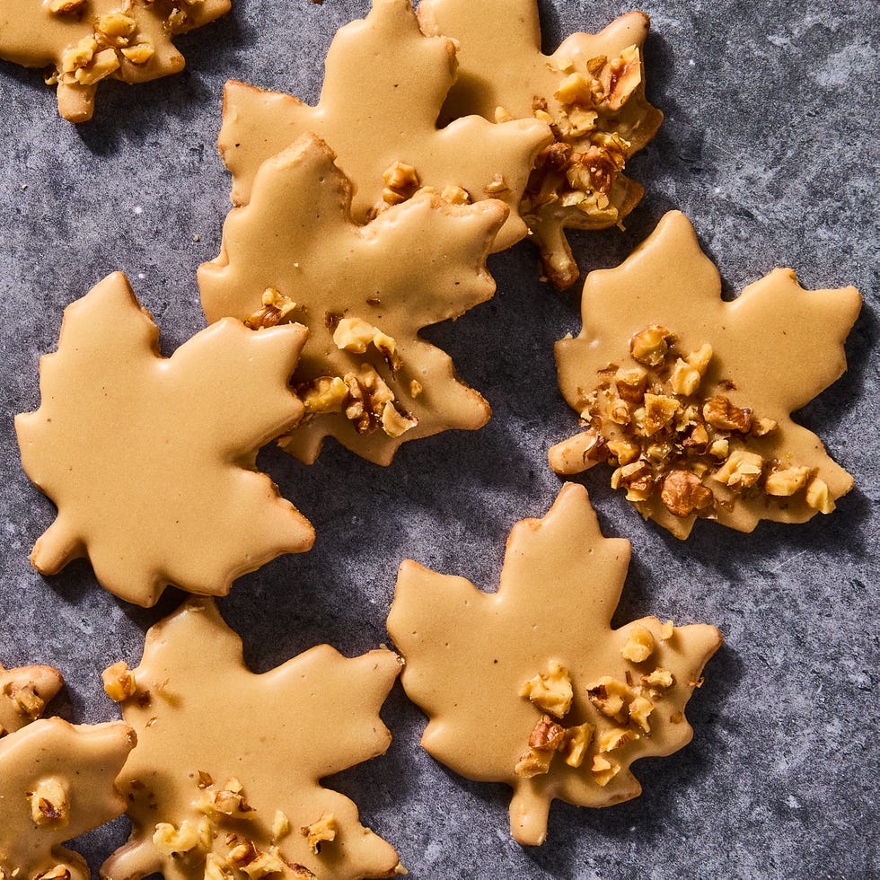 glazed maple leaf cookies topped with pecans