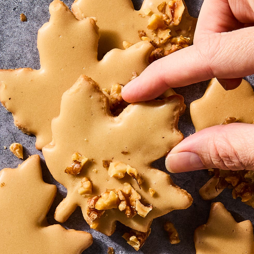 glazed maple leaf cookies topped with pecans