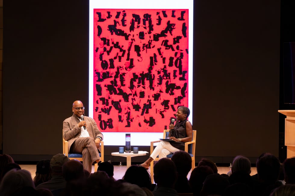 two people on stage discussing artwork
