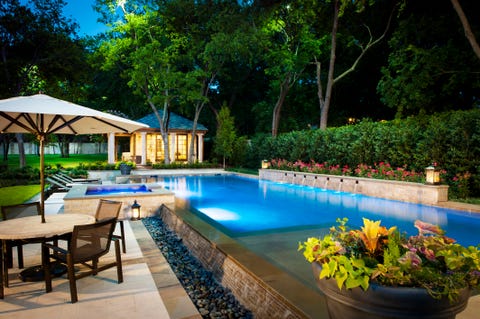 stone surrounded backyard swimming pool