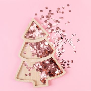 christmas tree shape with sparkles inside it on pink pastel background flat lay style christmas mood