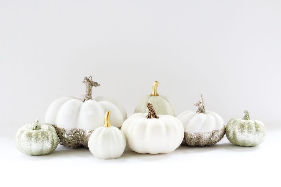 white modern pumpkin décor with glitter and metallic accents copy space