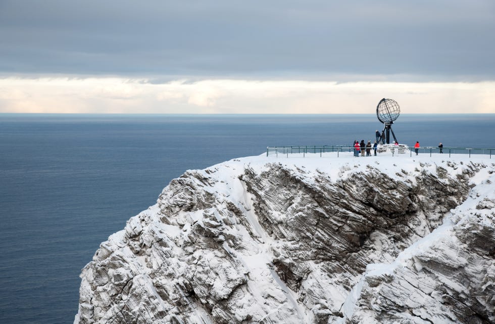 Globe Monument and tourist at North Cape, Northern Norway.