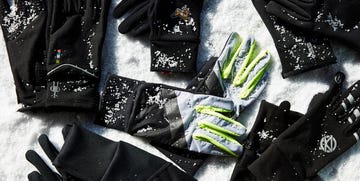 various gloves arranged on a snowy surface