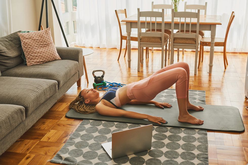 woman working out on a yoga mat at home