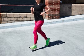 a woman running on pavement