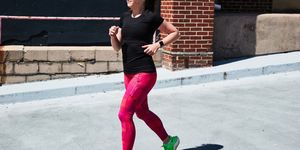 a woman running on pavement