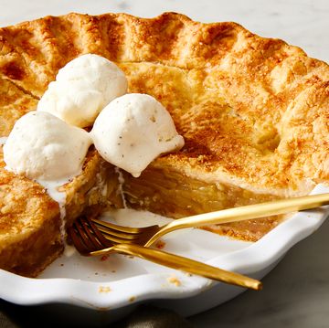 glutenfree apple pie in a white pie pan topped with vanilla ice cream