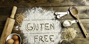 gluten free bread ingredients and utensils on wood frame background