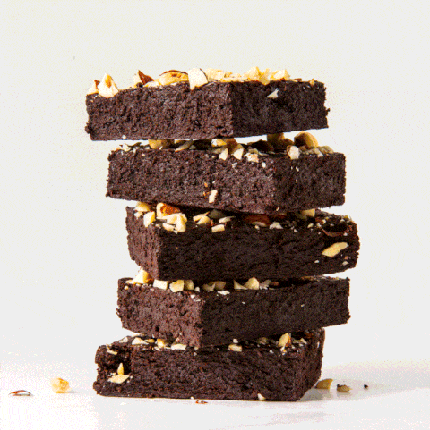 stack of gluten free brownies topped with nuts