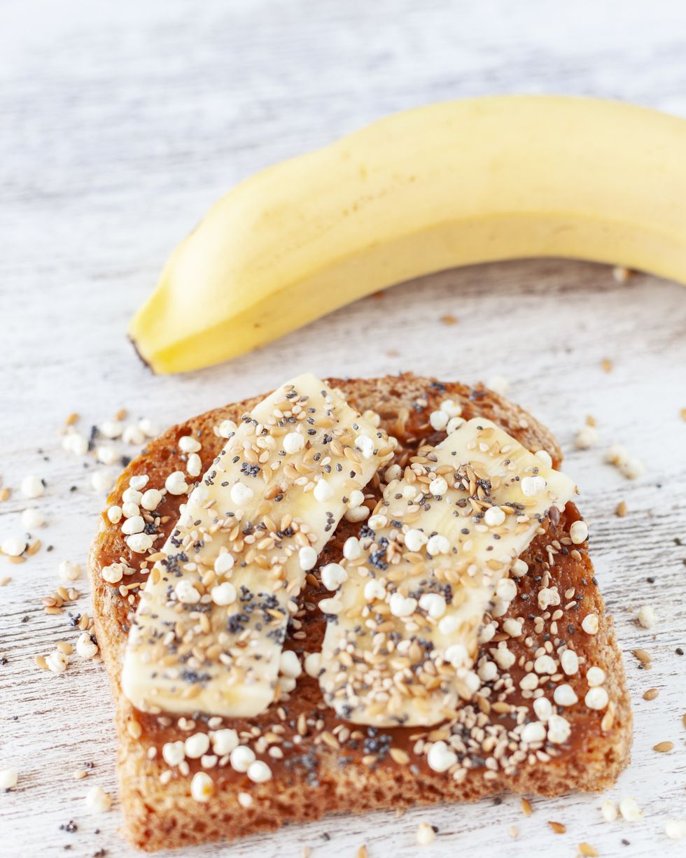 gluten free whole grain bread with almond butter, banana, puffed millet with honey, golden flax, chia, sesame and poppy seeds
