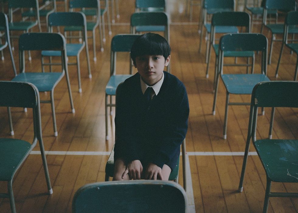 a boy sitting in a classroom
