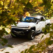 gmc hummer ev on country road in fall