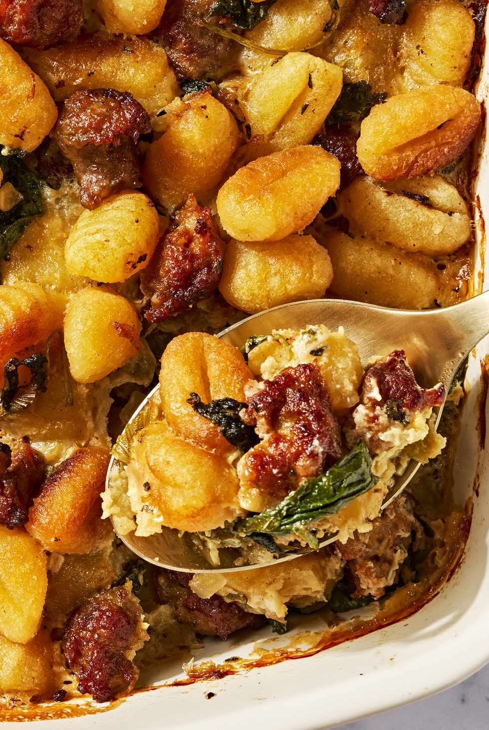 gnocchi and sausage stuffing in a white baking dish