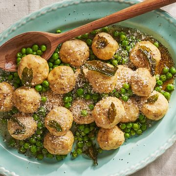 platter of gnudi with browned butter and peas and mint