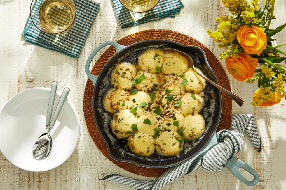 a bowl of gnudi with brown butter sauce