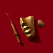 gold colored syringe and face mask on the red background