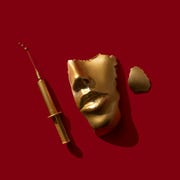 Gold colored syringe and face/ mask on the red background. gold colored syringe and face mask on the red background