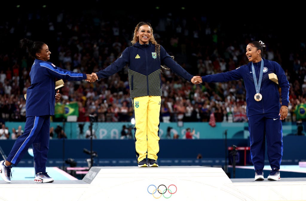 Women are dominating the 2024 Paris Olympics. On Team USA, they are taking home significantly more medals than the men and more than double the amount of golds, thanks to some history-making moments from Katie Ledecky and Simone Biles.  <br><br>Female athletes are winning off the podium too—by showing up for, speaking out in support of, and fangirling over each other—no matter the country, game, or score. At a time when the whole world feels divided on almost everything, watching rivals become BFFs reminds us of the healing power of good sportsmanship—and what women are capable of achieving when they are not being pitted against each other.  <br><br>Maybe it's the magic of brat summer, or the fact that a woman is running for the United States' highest political office. Whatever it is, Girlympics is in full force—and the femininomenon shows no signs of slowing down. After the jump, five gold medal-worthy moments of women supporting women at the Paris Games.