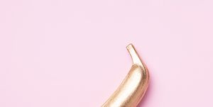 golden banana on pink background creative food concept top view flat lay single exotic gold fruit