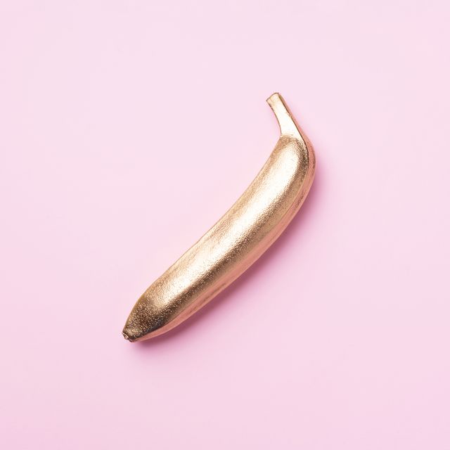 golden banana on pink background creative food concept top view flat lay single exotic gold fruit