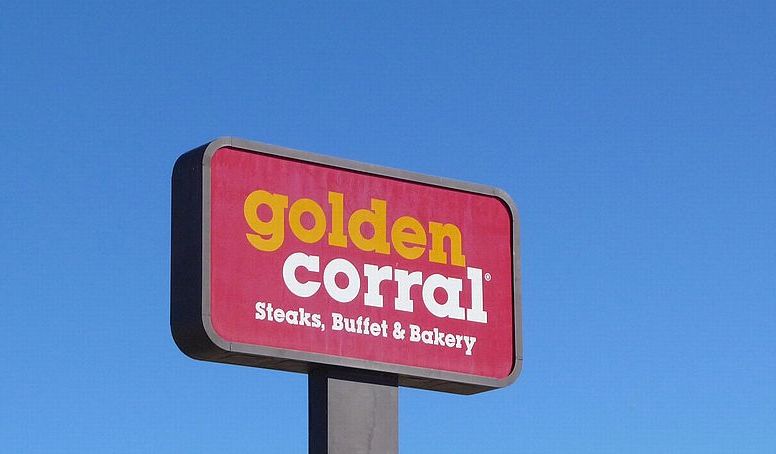 the sign towering over the golden corral parking lot in rock springs, wyoming