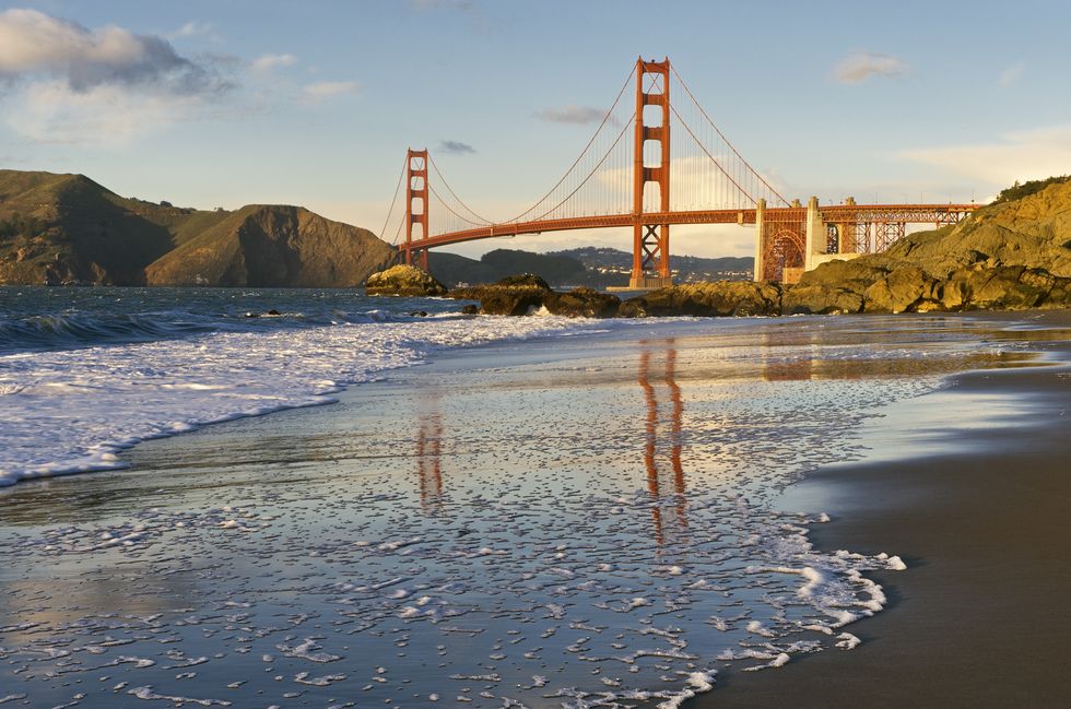 Golden Gate Bridge reflected on wet sand