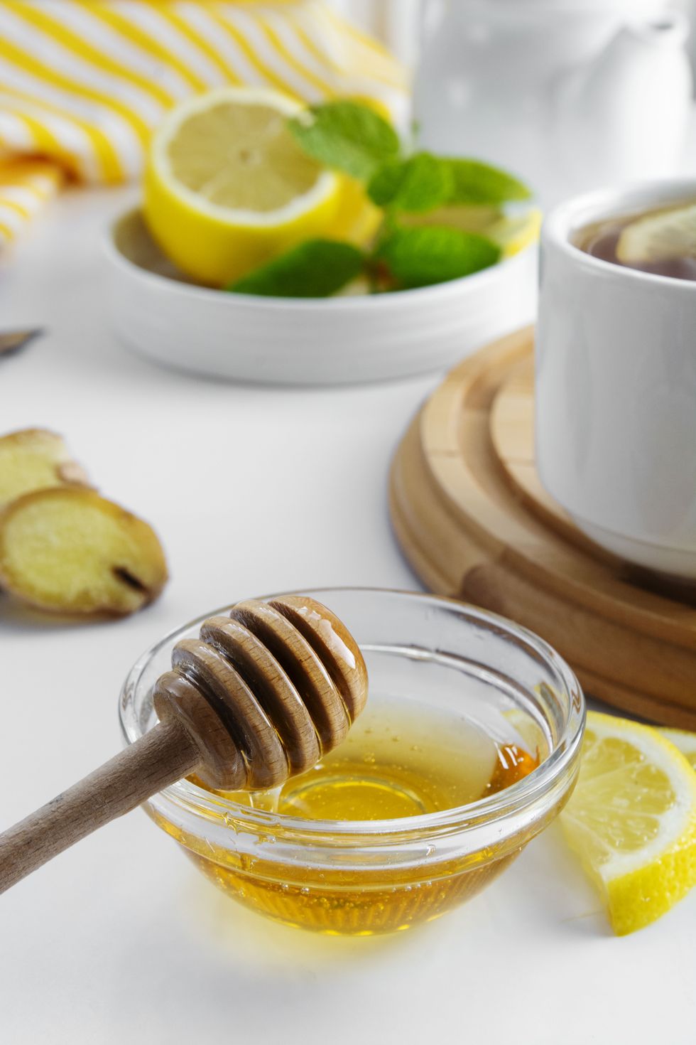 golden natural honey autumn winter hot drink ingredient glass bowl honey spoon seasonal