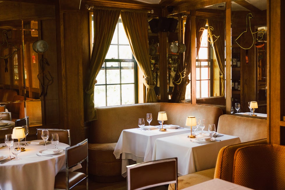 Elegant dining area with tables and upholstered seating