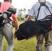 two men walking on course with golf bags