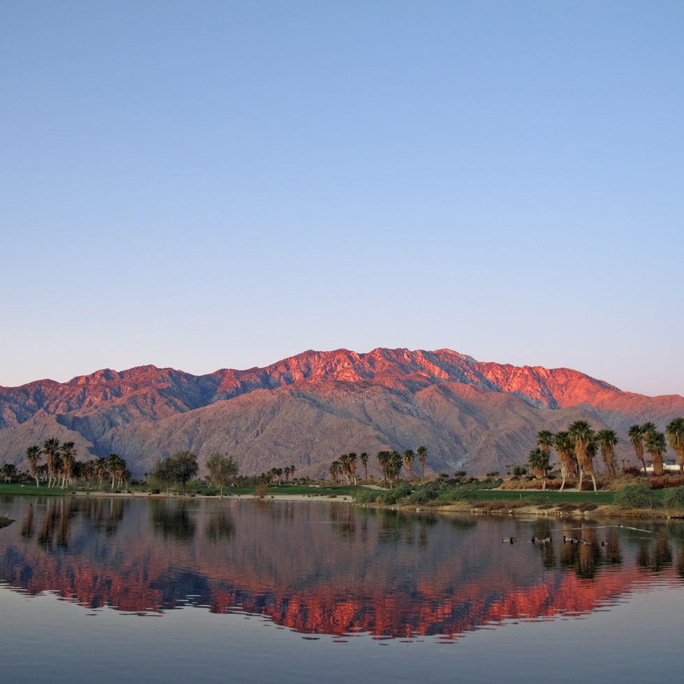 best honeymoon destinations in us palm springs golf course at dawn with sunrise kissed mountains