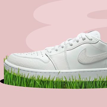 a pair of white sneakers on a green grass
