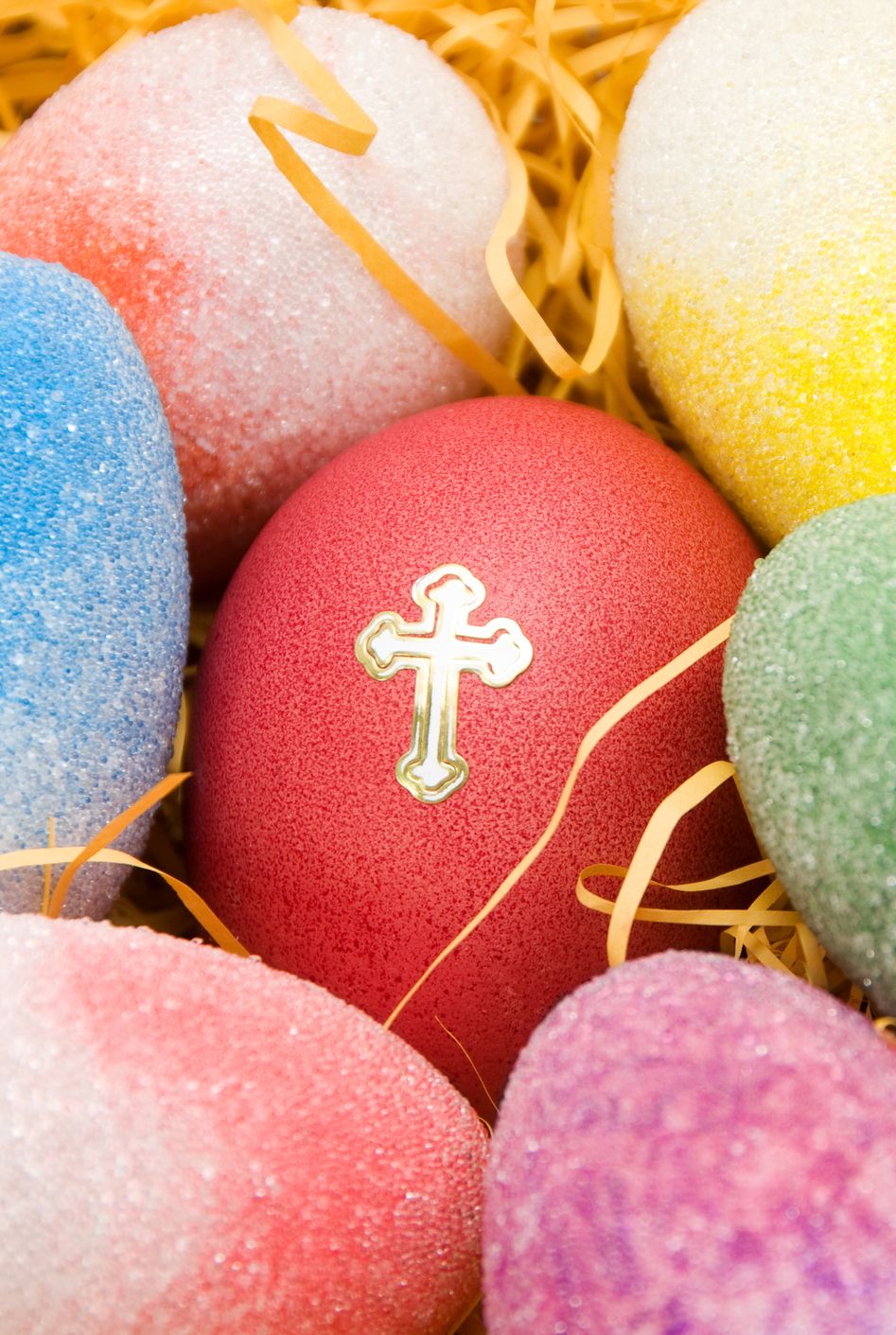 Good Friday Colorful Easter Egg with Holy Cross in Hay