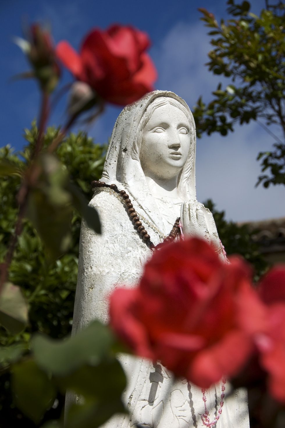 Good Friday Facts Statue of Virgin Mary with Red Roses