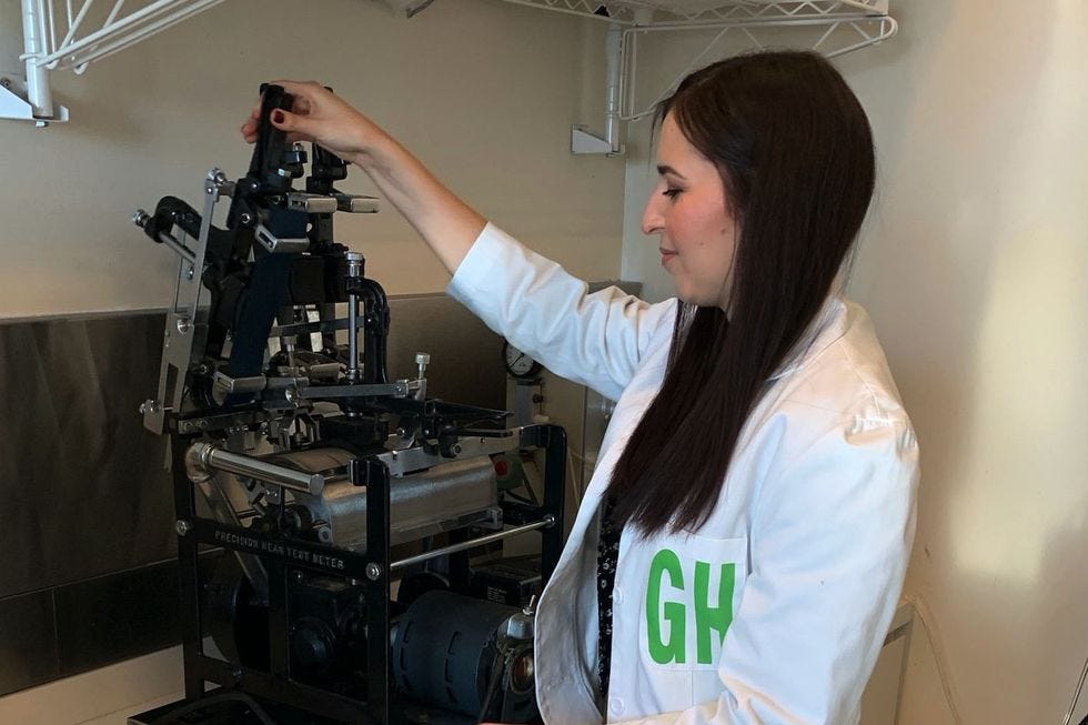 a gh analyst loading material into the abrasion tester to evaluate the durability of softside material