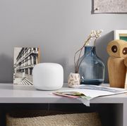 google nest wifi on home shelf