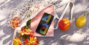 google pixel 4a in market bag with flowers and orange