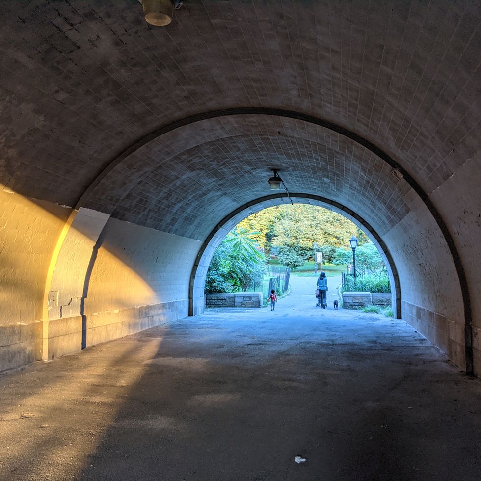 underpass in central park with kid and mom with stroller