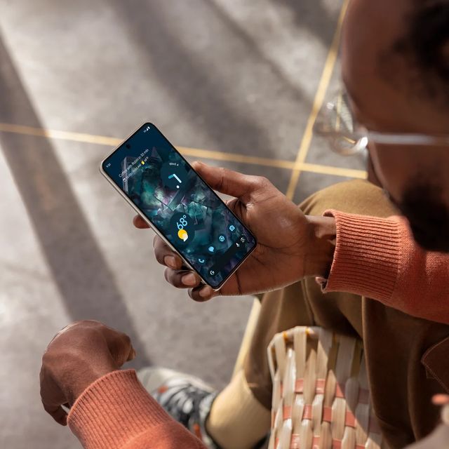 a person holding a google pixel 8
