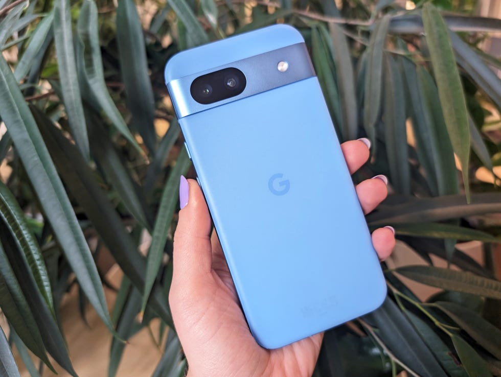 google pixel 8a held in hand with purple nails