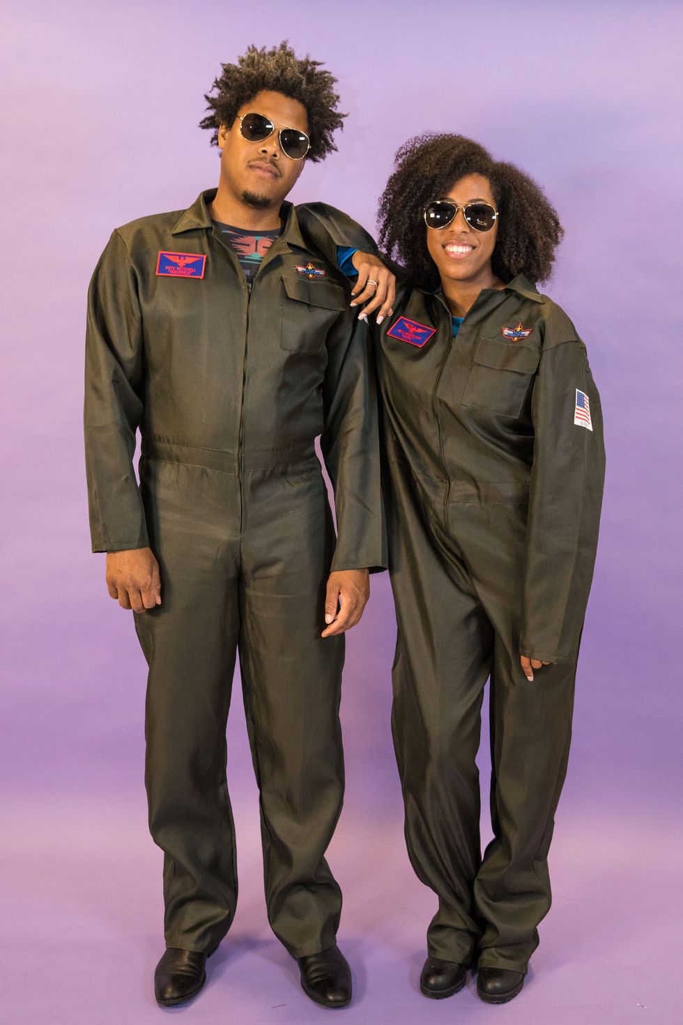 a man and woman wearing aviator suits and shades as part of a top gun goose and maverick couples costume