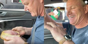 gordon ramsay in a car holding a sandwich